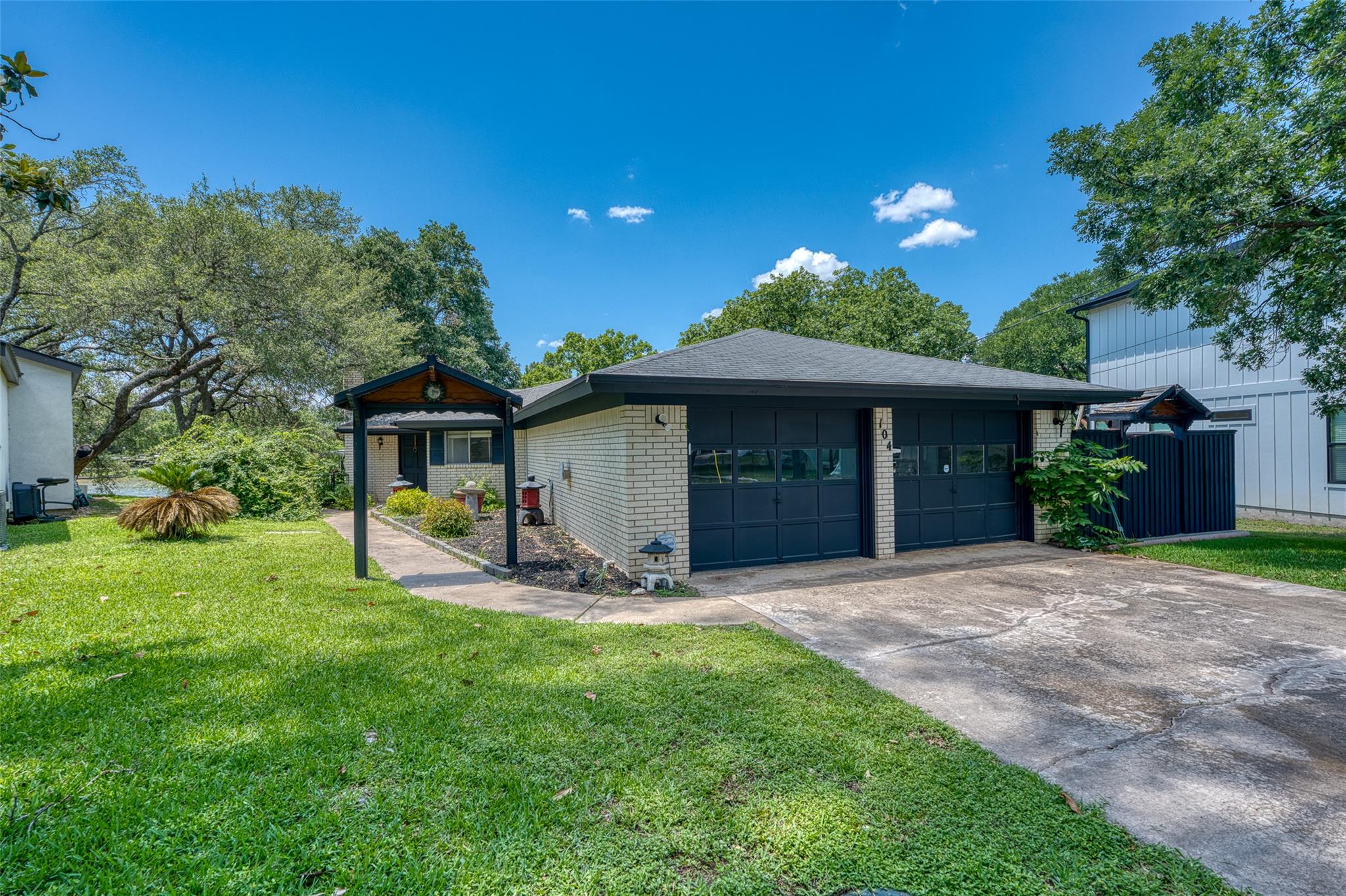 104 Bluebird Ln, Highland Haven, TX 78654 — handicap-accessible one-story waterfront home on Lake LBJ with two-car garage and carport, listed by D. Green & Associates