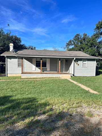 118 E Pine Drive, Granite Shoals, TX 78654 — single-story home with covered front porch and brick chimney, listed by D. Green & Associates